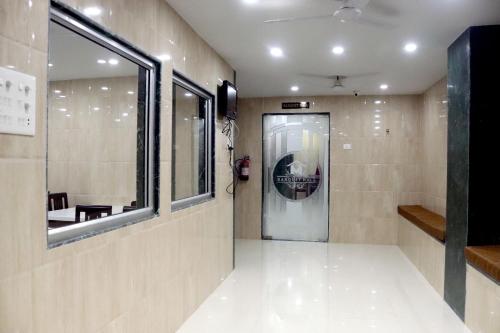 a bathroom with a walk in shower and a mirror at THE HOTEL MILLENNIUM in Imphal