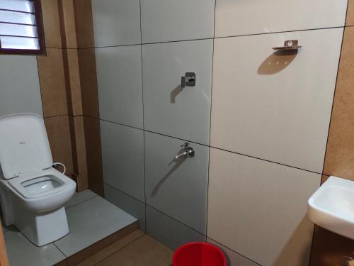 a bathroom with a toilet and a sink at MALABAR Residency in Perintalmanna