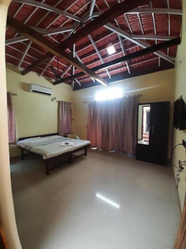 an empty room with a bed in the middle of it at Triskelion - Bed and Breakfast, Family home stay by Joshi Brothers in Dapoli