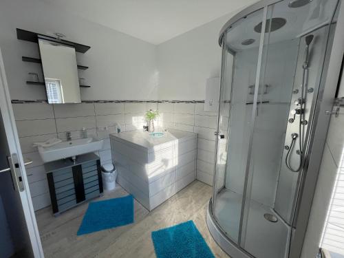 a bathroom with a sink and a shower at Ferienhaus am Baybach in Burgen an der Mosel in Burgen