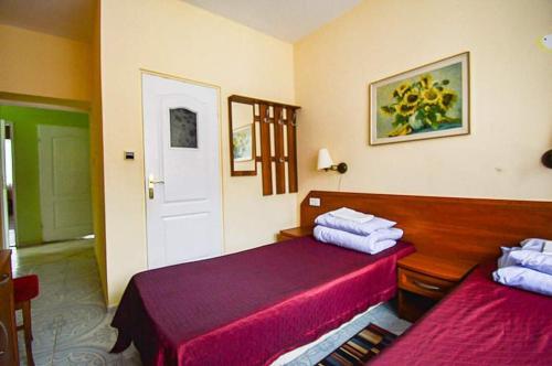 a hotel room with two beds with red sheets at OŚRODEK WYPOCZYNKOWY MAZOWSZE W KARPACZ in Karpacz
