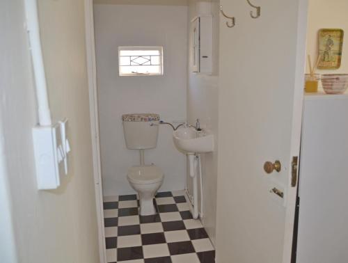 a small bathroom with a toilet and a sink at The Lemon Tree in Prince Albert
