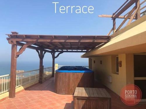 a hot tub on the balcony of a house at Amazing sea view Pentahouse Apartment in Pyramids Porto El-Sokhna in Ain Sokhna