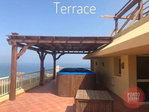 a hot tub on the balcony of a house at Amazing sea view Penthouse Apartment in Pyramids Porto El-Sokhna in Ain Sokhna