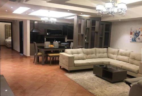 a living room with a couch and a table at Amazing sea view Penthouse Apartment in Pyramids Porto El-Sokhna in Ain Sokhna