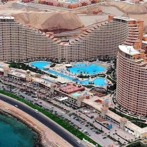 an aerial view of a resort with many pools at Amazing sea view Penthouse Apartment in Pyramids Porto El-Sokhna in Ain Sokhna