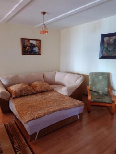a living room with a couch and a table at Apartament pod Zakrytym Mostem in Lądek-Zdrój