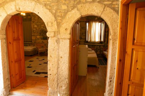 a room with two arched doors and a bedroom at annemin harabesi otel in Çeşme