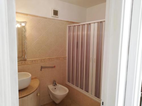 a bathroom with a sink and a toilet and a shower at Casa Afrodite in Praiano