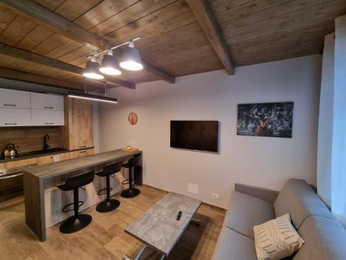 a living room with a couch and a bar at Moda Apartments 38 in Sestriere