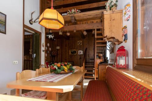 a kitchen with a table with a bowl of fruit on it at Condominio Pien dal Lat in Selva di Cadore