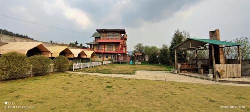 a large house with a large yard in front of it at Silver Brook Resort Mylliem Upper Shillong in Shillong