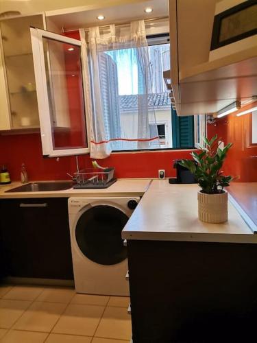 a kitchen with a washing machine and a sink at Santi Padri Apartment in Corfu