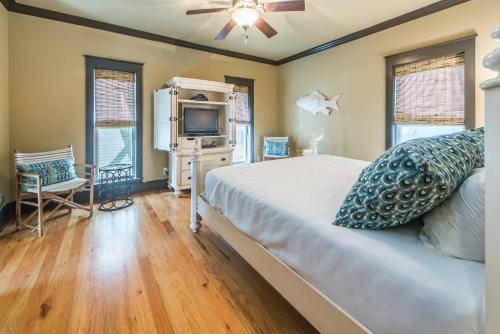 a bedroom with a bed and a tv in it at Comfort and Joy in Seacrest