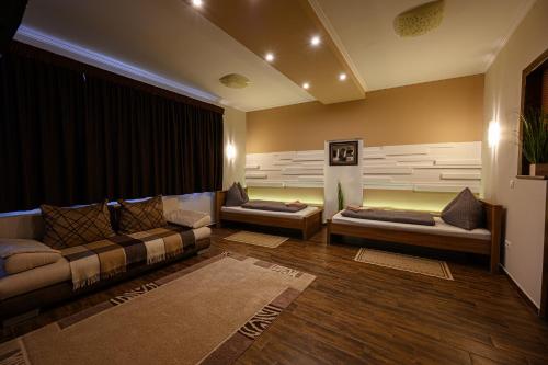 a living room with two couches and a large window at Nádasdi Ház in Szekszárd