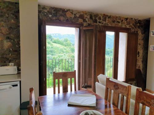 a kitchen with a table and a window with a view at Turismo Rural Casa del Batlle in Sarroqueta
