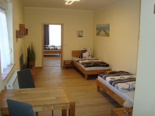 a room with two beds and a table in it at Trothaer Eck in Kröllwitz