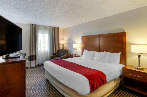 a hotel room with a large bed and a television at Comfort Inn Atkins-Marion I-81 in Atkins