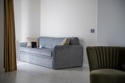 a living room with a couch and a chair at Savoia Hotel Rimini in Rimini