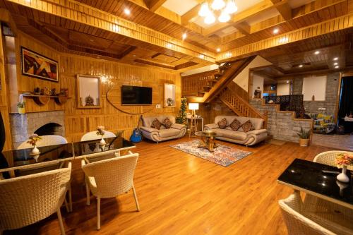 a large living room with a couch and a fireplace at Amarys Boutique Stays Manali in Manāli