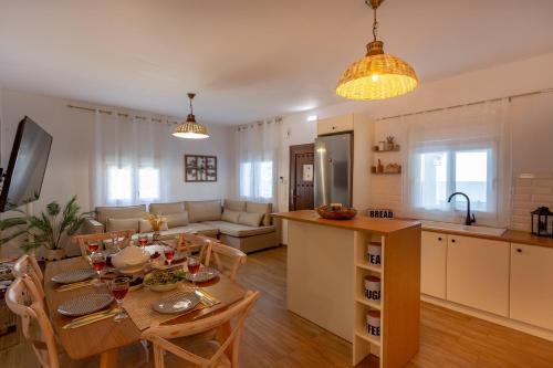 a kitchen and a living room with a table and chairs at Villa Thalassa in Skaleta