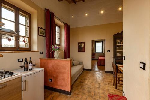 a kitchen and living room with a couch and a table at Wine Resort Colsereno in Montalcino