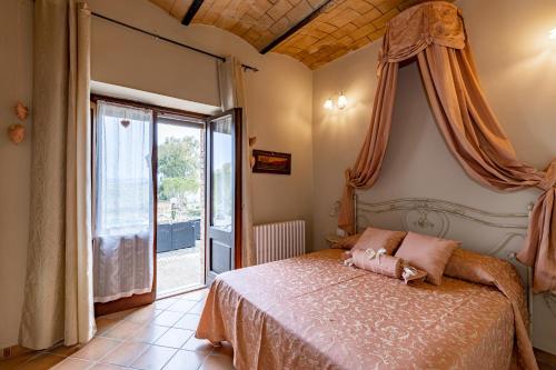 a bedroom with a bed and a large window at Wine Resort Colsereno in Montalcino