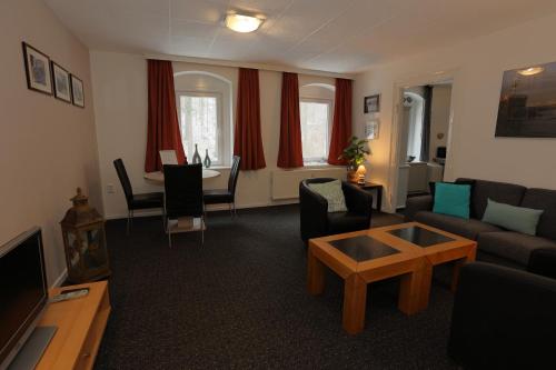 a living room with a couch and a table at Haus Stefanie Elvire in Kurort Altenberg