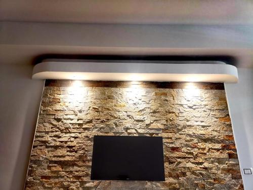 a stone fireplace with lights on top of it at Jana apartment 2 in Ohrid