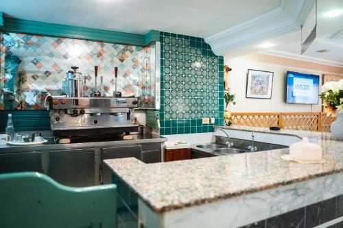 a kitchen with a sink and a counter top at Hôtel Résidence Monia in Sousse