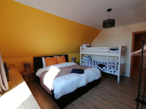 a bedroom with a bed and a white crib at 't Zuden van Aertrycke in Zedelgem