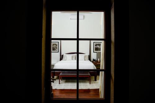 a view of a bedroom with a bed through a window at Hotel Casa Blanca 7 in San Miguel de Allende