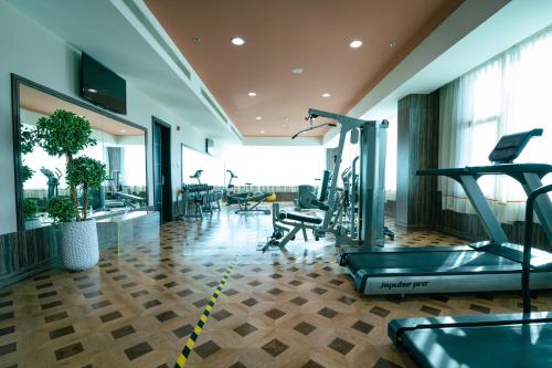 a gym with treadmills and ellipticals in a building at Arman Hotel Juffair Mall in Manama
