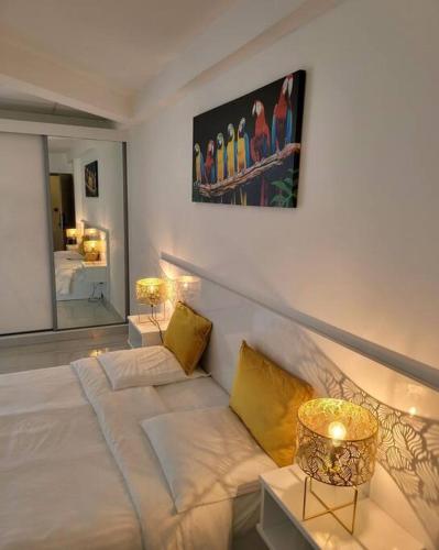 a room with a bed and a painting on the wall at Hello Guyane (4), Suite Junior Luxury, 5 étoiles in Cayenne