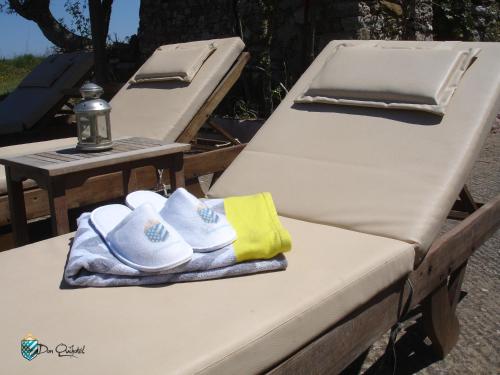 two beds with hats and towels sitting on them at DonQuihotel Chalet in Karvounádhes