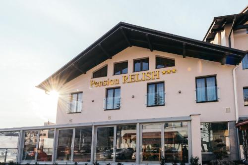 a building with a sign on the front of it at Pension Relish in Rajecké Teplice