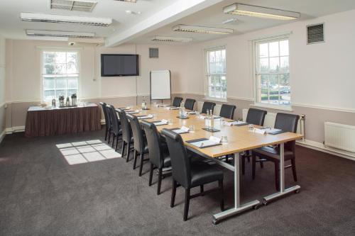 a conference room with a long table and chairs at The Regency Hotel in Solihull