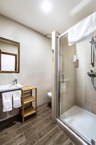 a bathroom with a shower and a sink and a toilet at Pension Relish in Rajecké Teplice