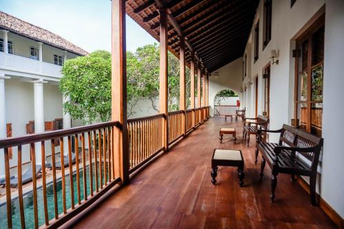 an empty porch with wooden floors and windows at Galle Fort Hotel in Galle
