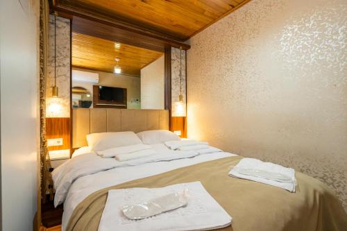 a bedroom with a large bed with towels on it at Candy Hotel in Istanbul