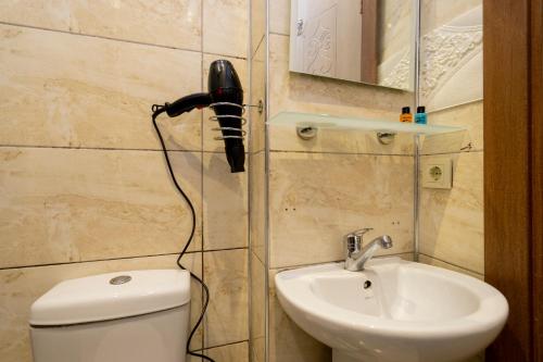 a bathroom with a black hair dryer hanging on the wall at Candy Hotel in Istanbul