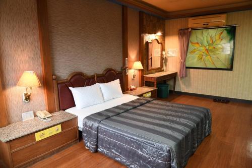 Un dormitorio con una cama grande en una habitación. en Love Boat Motel, en Chaozhou