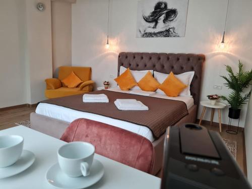 a bedroom with a bed with two cups on a table at VILA MRV in Constanţa