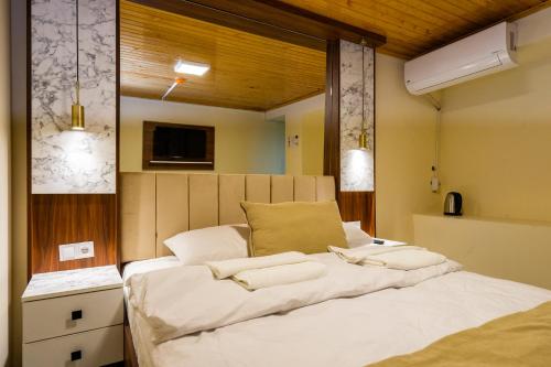 a bedroom with a large bed with white sheets at Candy Hotel in Istanbul