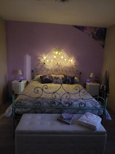 a bedroom with a bed with a wrought iron headboard at La BedOlla '41 Tortona in Tortona