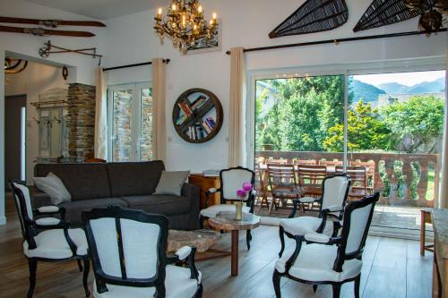 a living room with a couch and chairs and a table at Villa Art Natura in Juzet-de-Luchon