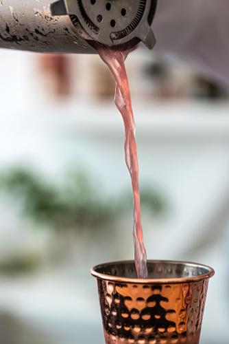 a drink is being poured into a cup at Nissaki Boutique Hotel in Platis Yialos Mykonos