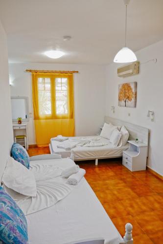 a living room with two beds and a couch at Jasmine apartments in Pythagoreio