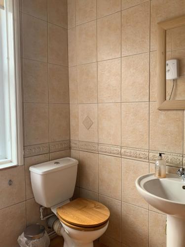 a bathroom with a toilet and a sink at The Pines Guest House in Whitley Bay