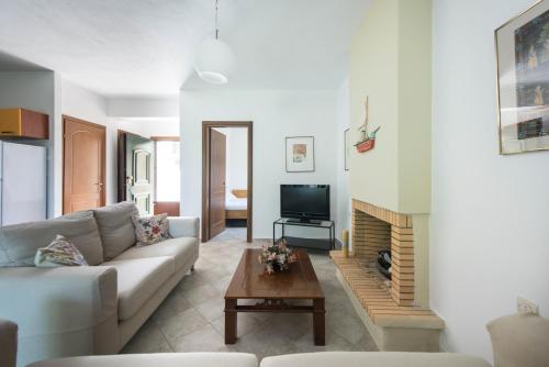 a living room with a couch and a fireplace at Psi·Theros in Kriopigi